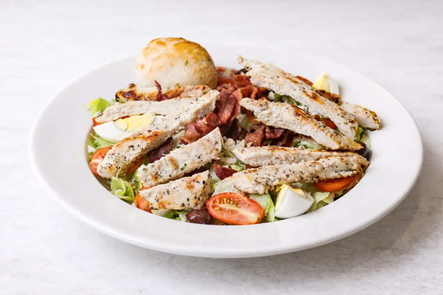 Caesar salad with grilled chicken, romaine and shaved parmesan
